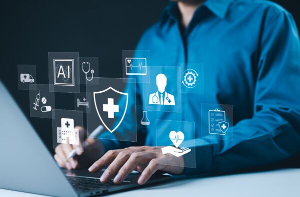 AI-Driven Healthcare and Medical Technology Concept. A professional using laptop with digital AI powered healthcare icons, medical services, data protection, and healthcare technology advancements.